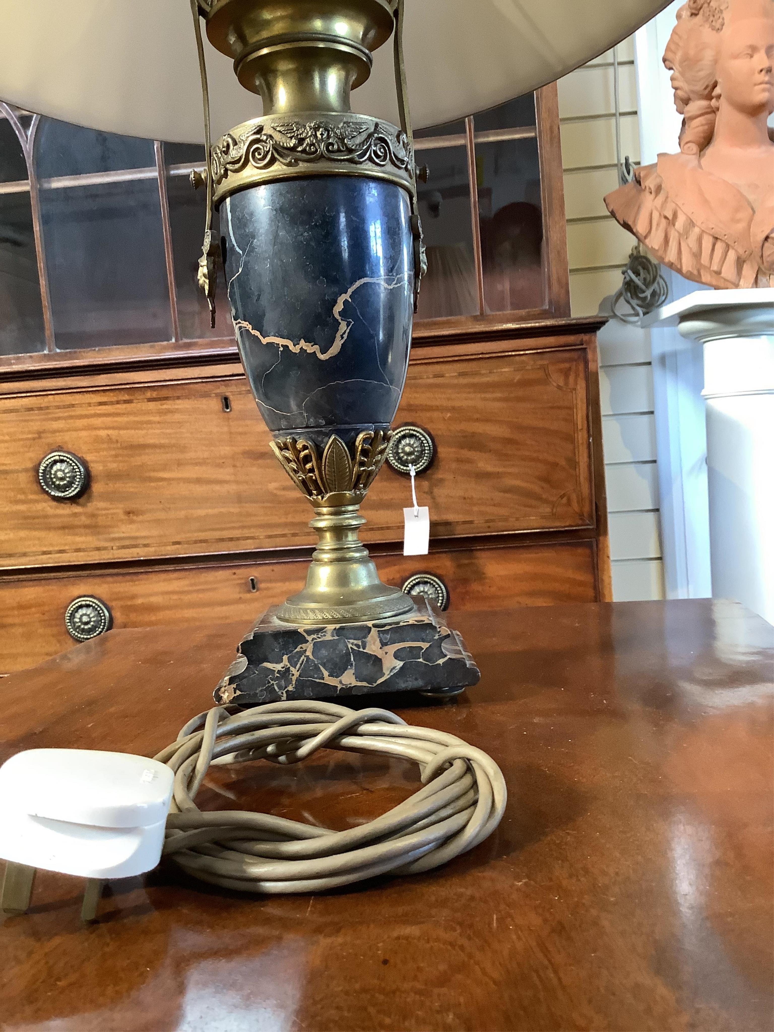 A pair of French Empire style ormolu mounted black marble table lamps